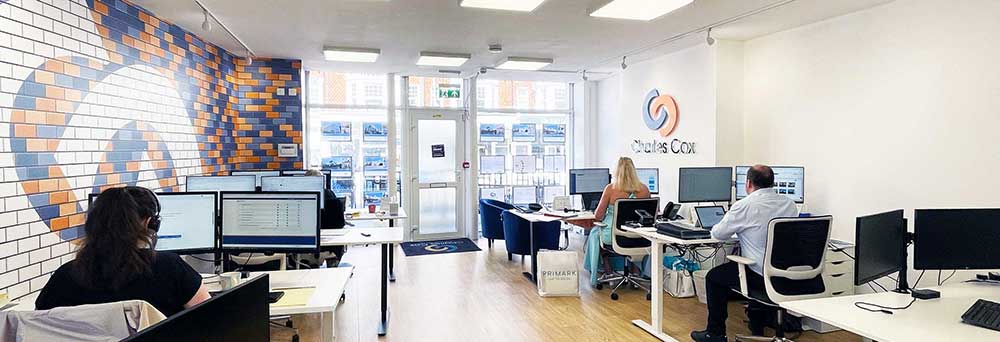 interior of the Charles Cox Property Lettings office with desks and staff