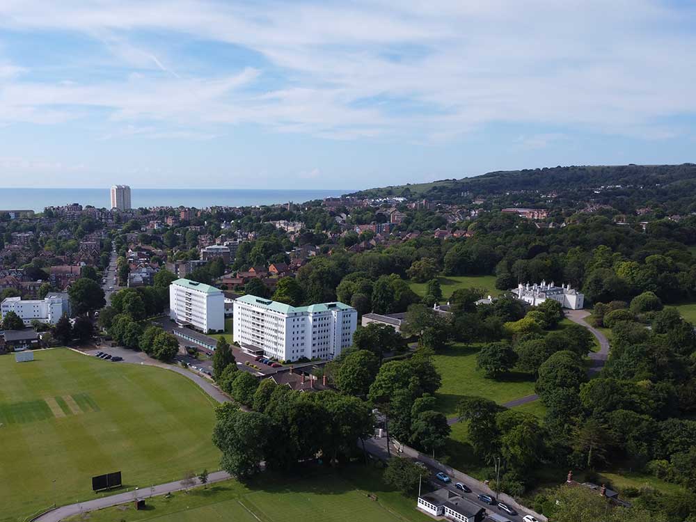 View over Eastbourne showing cricket ground, golf links and sea in the background