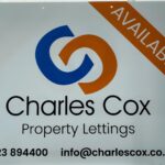 Charles Cox signage with contact information