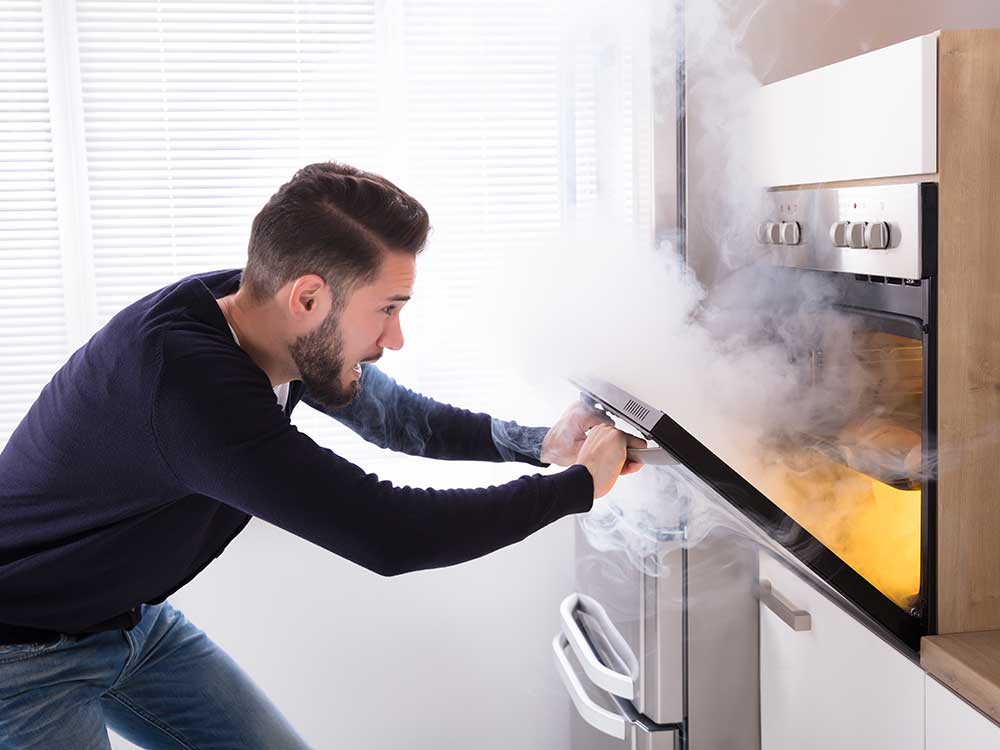 Fire safety message showing man opening oven door and a fire starting