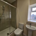 shower room with heated towel rail and window with views